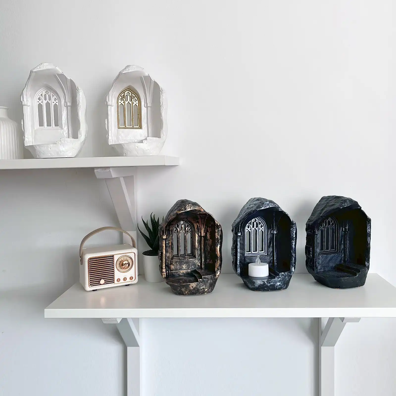 Five Magic Castle candle holders displayed on shelves