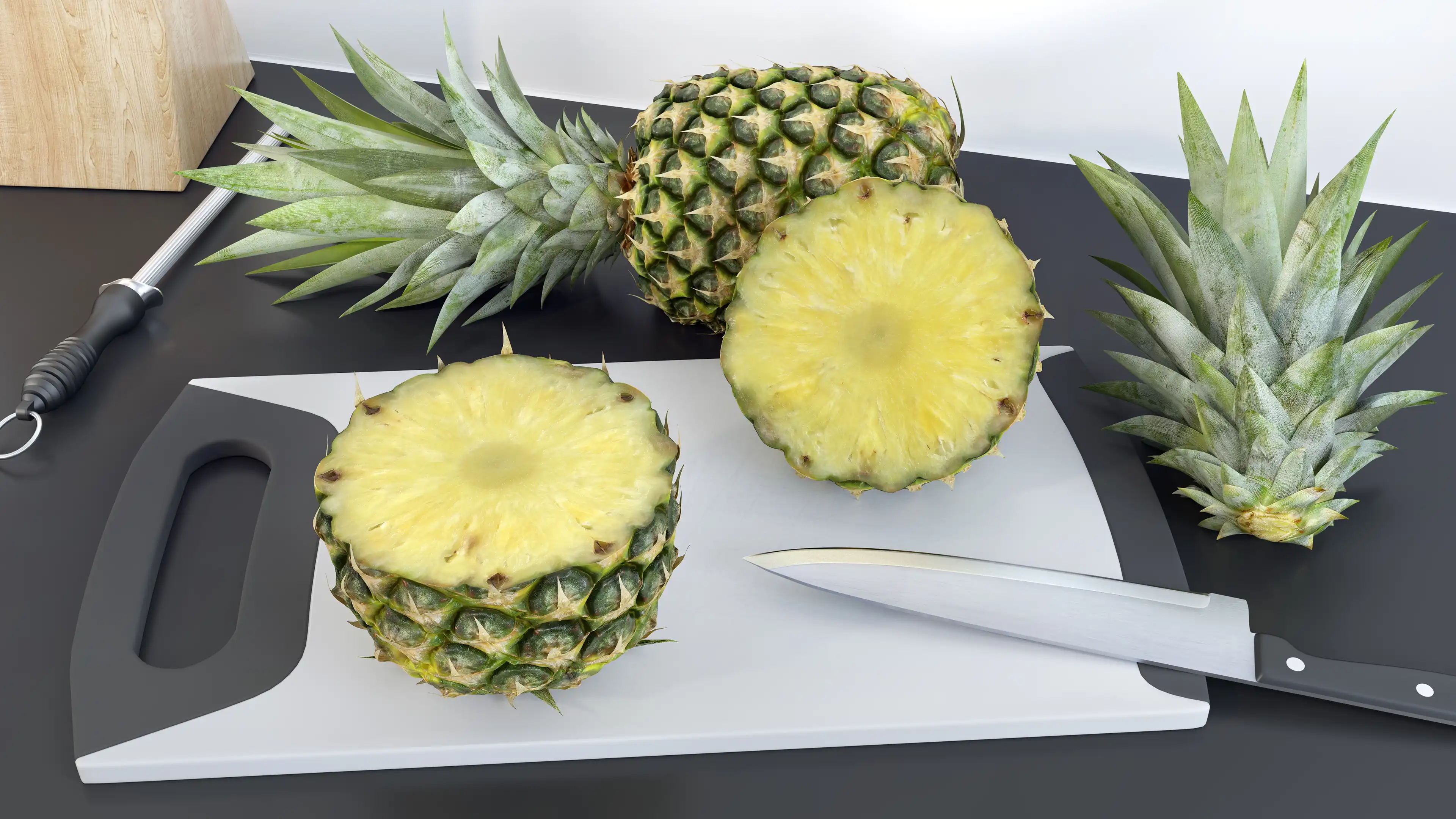 Pineapple, cut in half, lying on a kitchen cutting board. Pineapple cross sections close up.