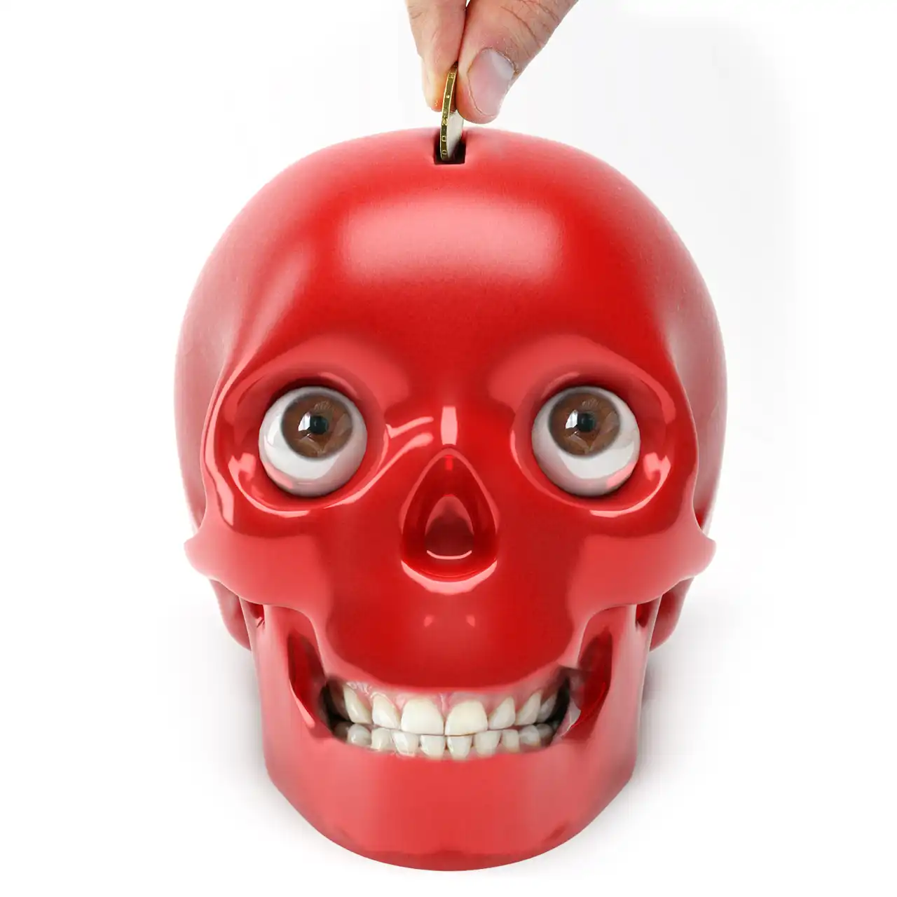 Illustration with a hand putting a coin in a piggy bank in the form of a skull with real human eyes and teeth. A 3d model of ceramic money box is used.