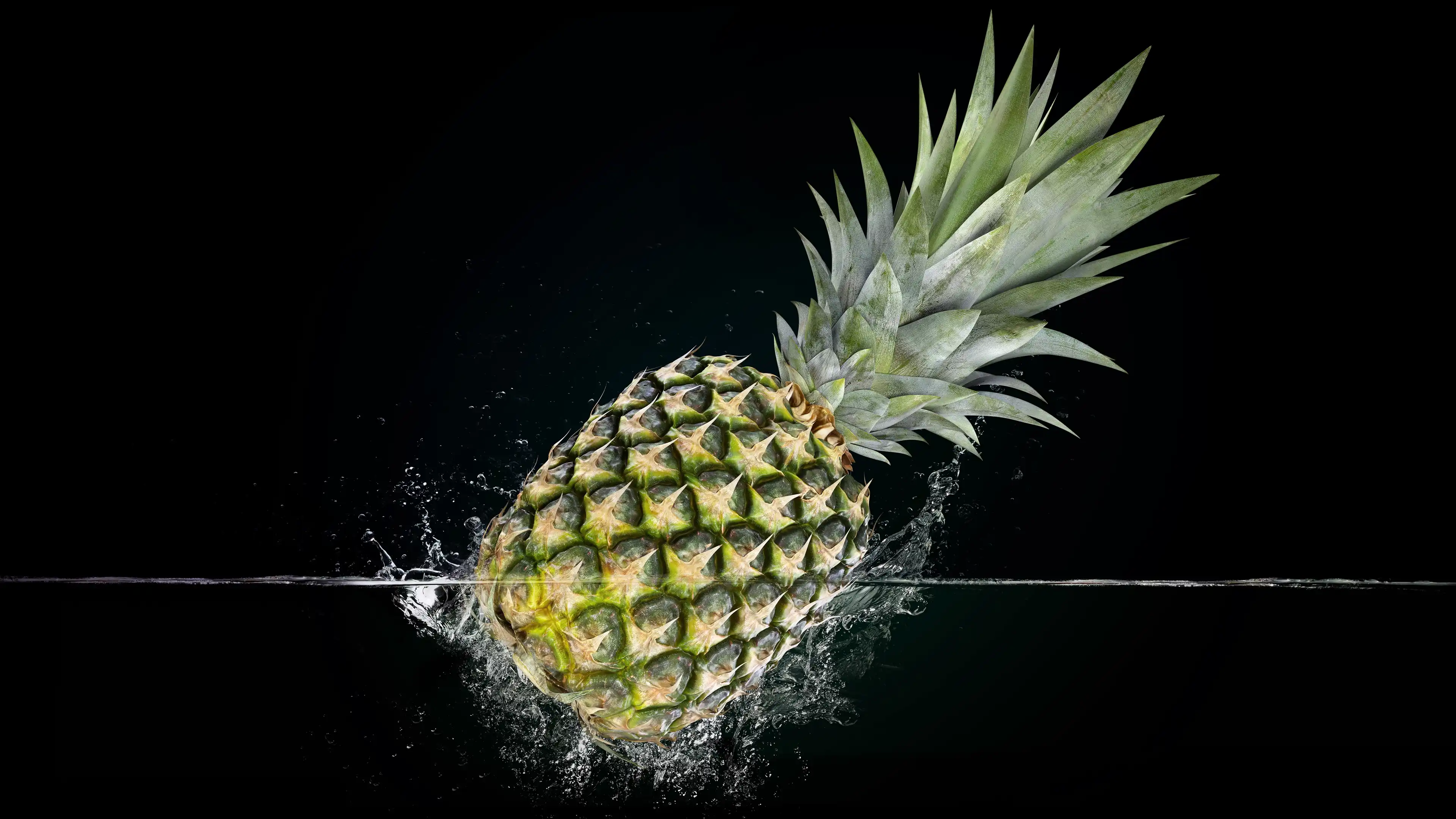 Pineapple on a black background with water splashes. 4K